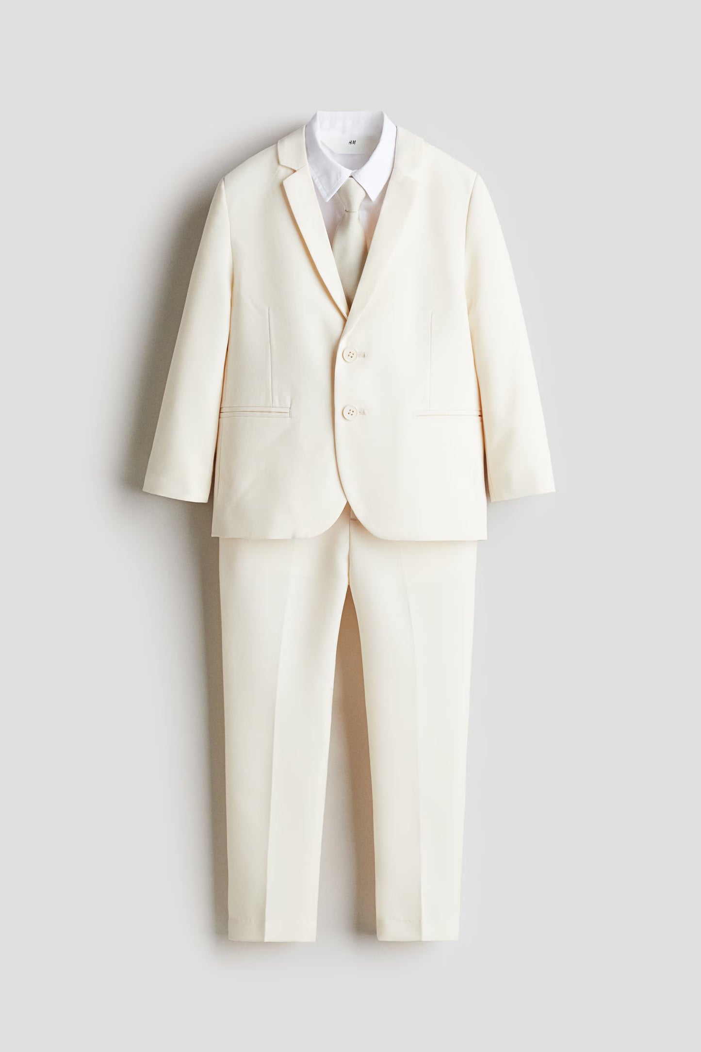 Set 4 piezas formal saco pantalon corbata camisa blanca beige niño H&M 1242064002