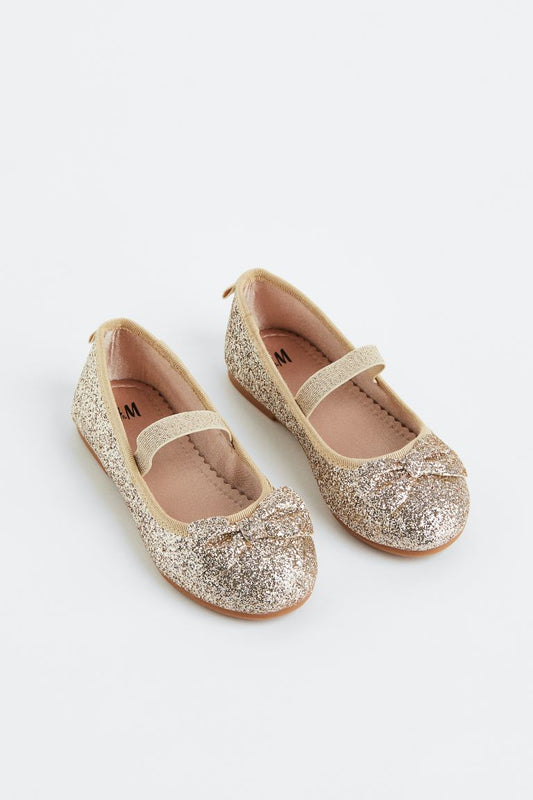 Zapatillas doradas chongo H&M niña