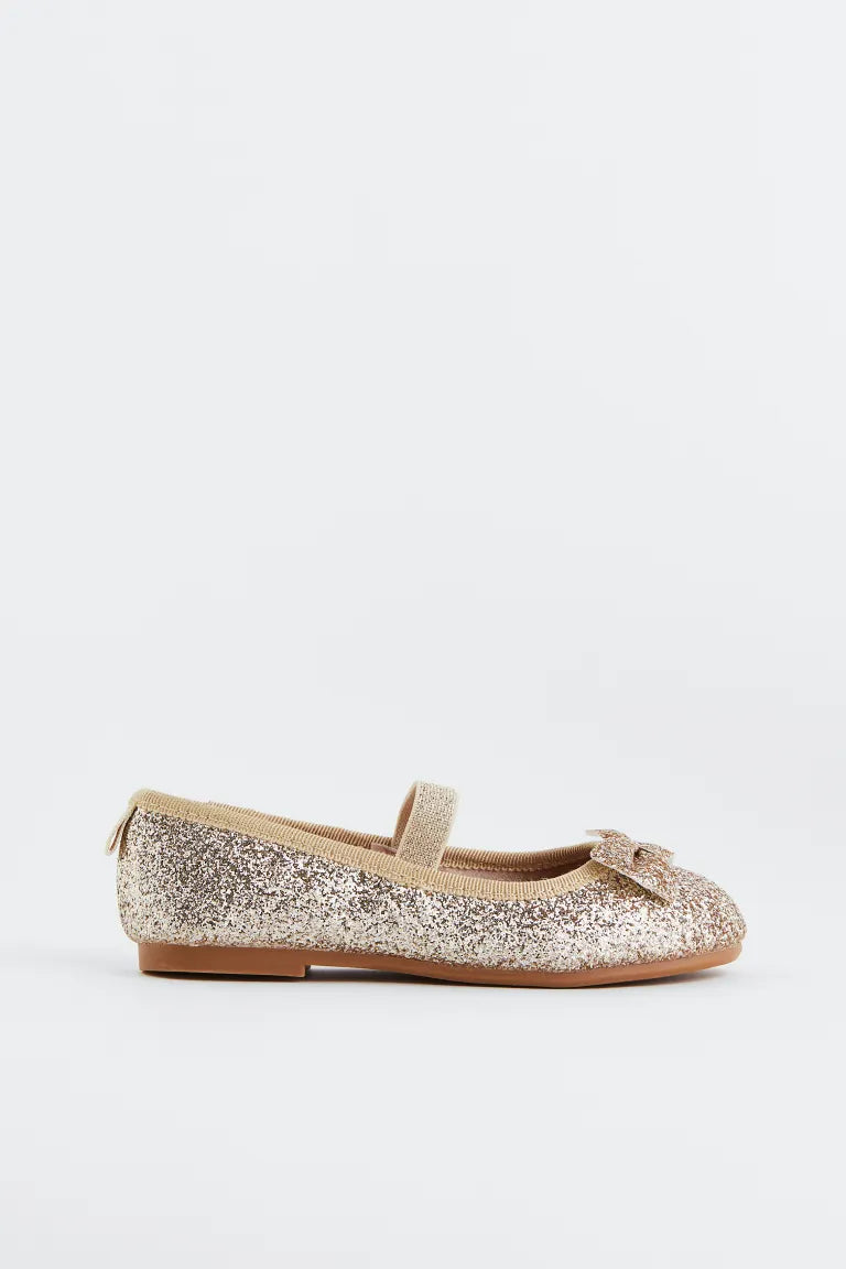 Zapatillas doradas chongo H&M niña
